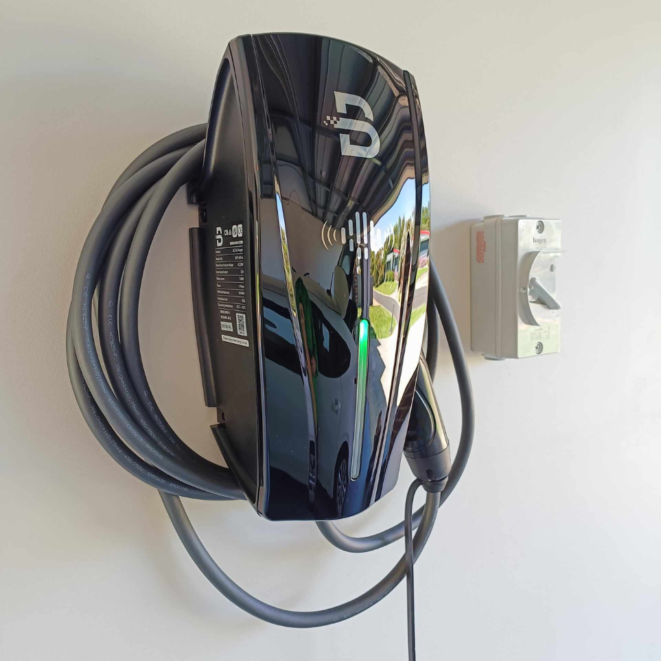 Close up view of black Beny EV charger that is mounted on the wall.