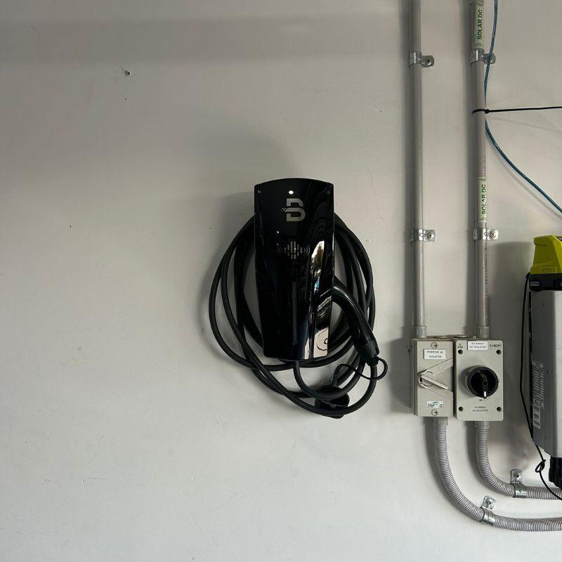 Black ZHJ Beny electrical EV charging station on a white wall