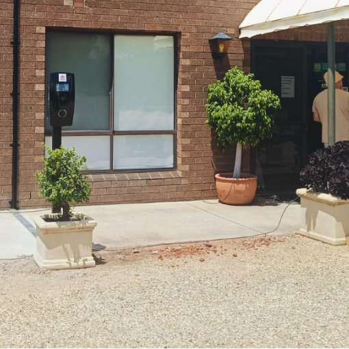 black ev charging station mounted on a pole