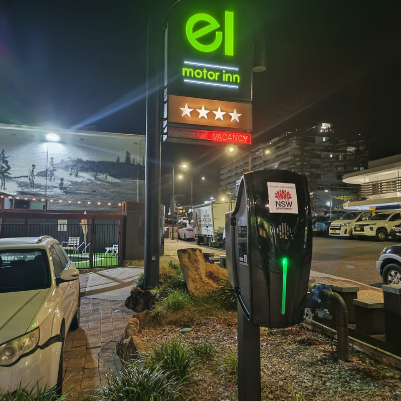 black EV charger installed on an outside setting