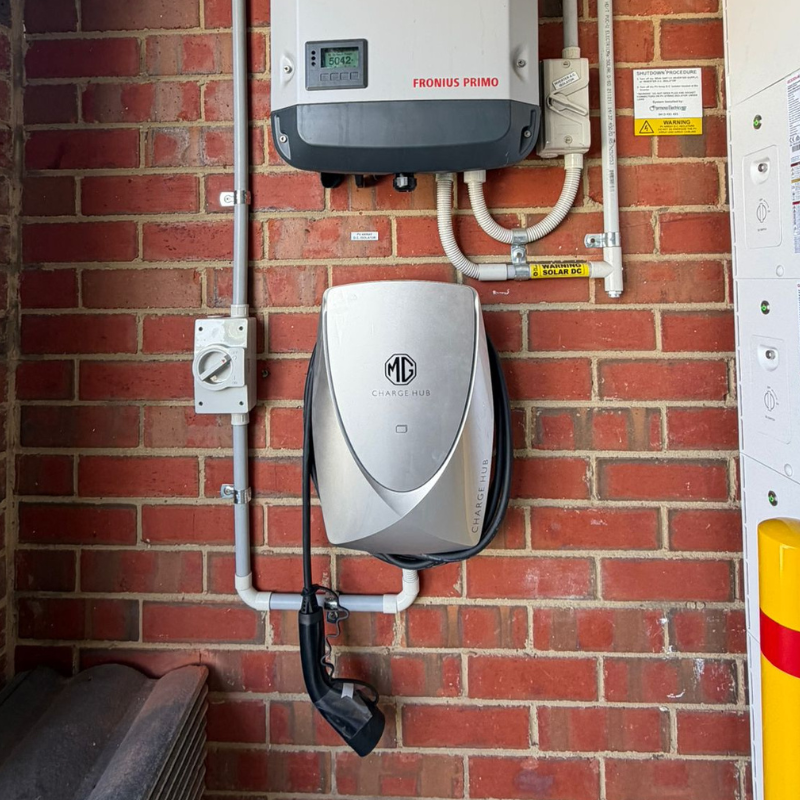 Electric vehicle charging station on a brick wall