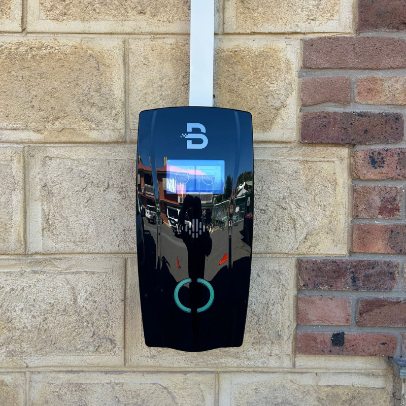 Black electronic device on a brick wall