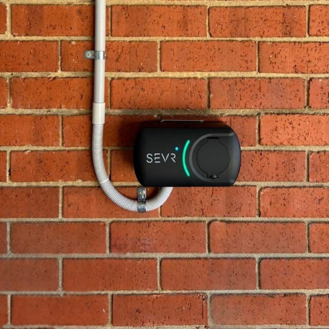 black SEVR charger mounted on a brick wall