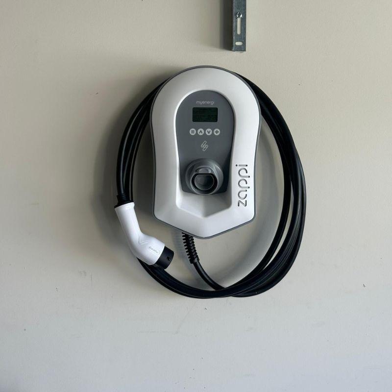 Zappi electric vehicle charging station on a white wall