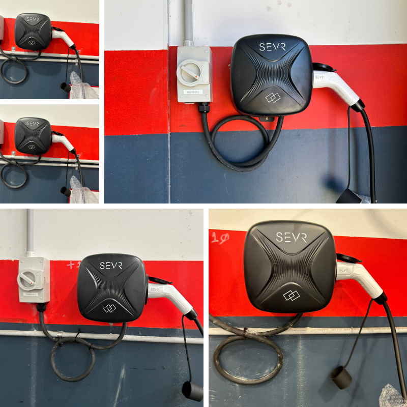 SEVR charging station with cables on a red wall