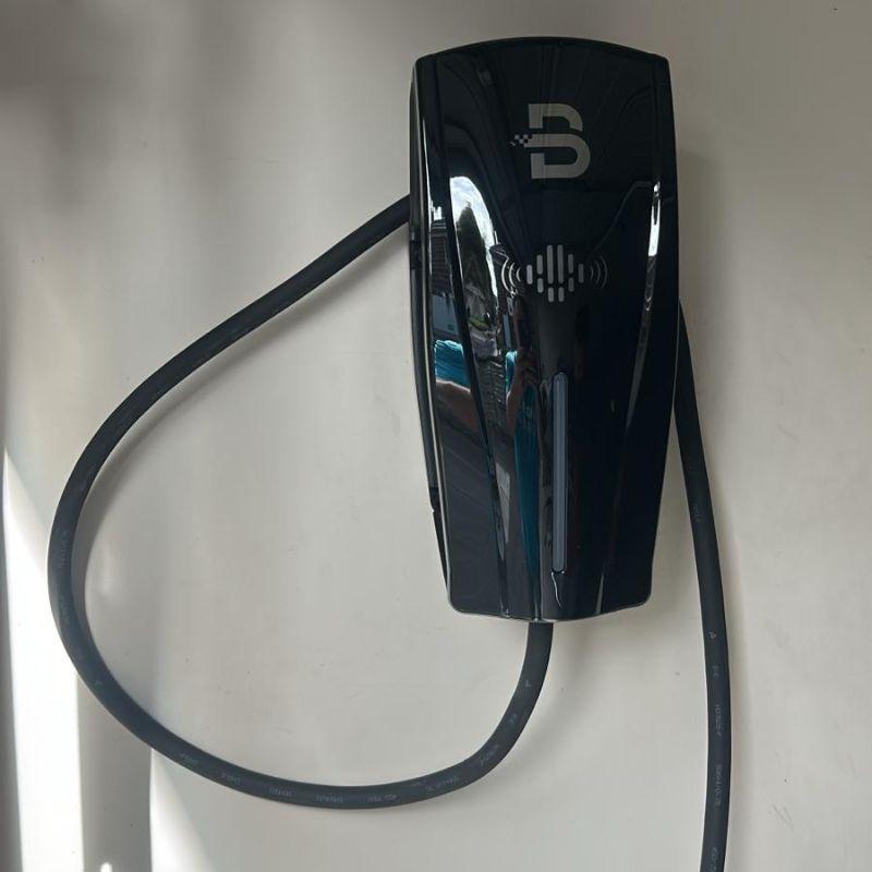 Black ev charger on a wall