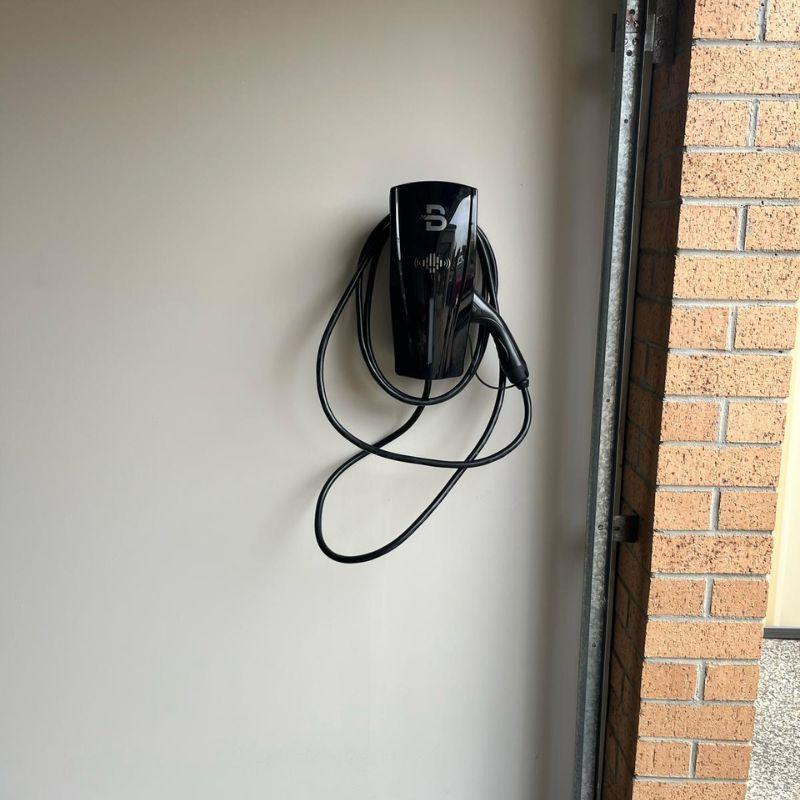 Black Beny electric vehicle charging station mounted on a wall