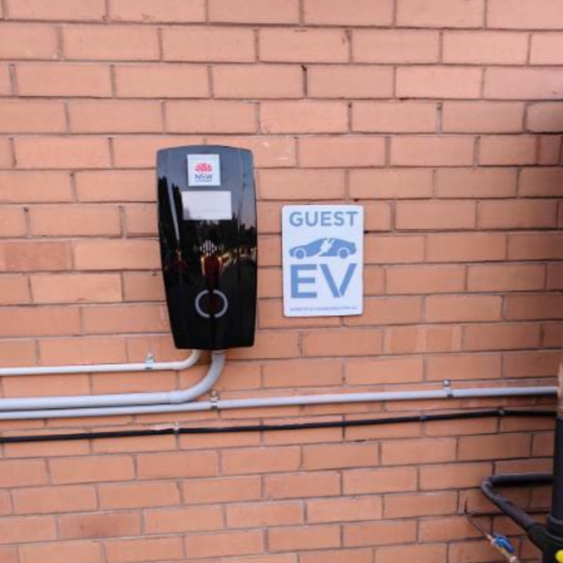 Electric vehicle charging station mounted on a brick wall 