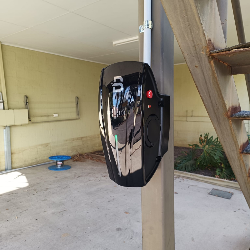 Black EV charging unit installed on a garage