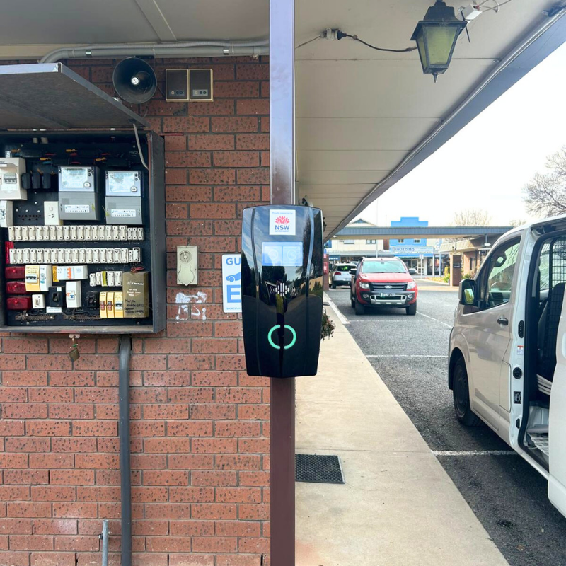 black EV charging  device installed on a parking area