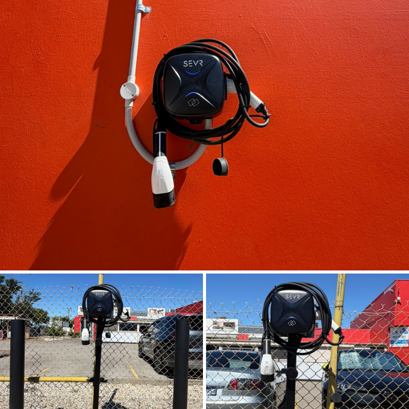 SEVR electric vehicle charging station mounted on a red wall  and some on the pole