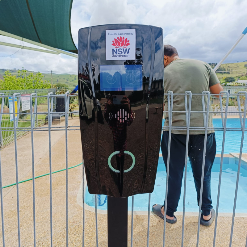 black ev charging unit near a pool area