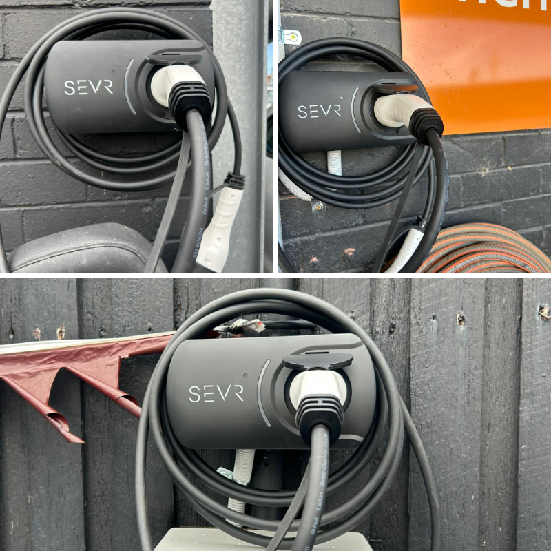 SEVR electric vehicle charger attached to a grey brick wall 