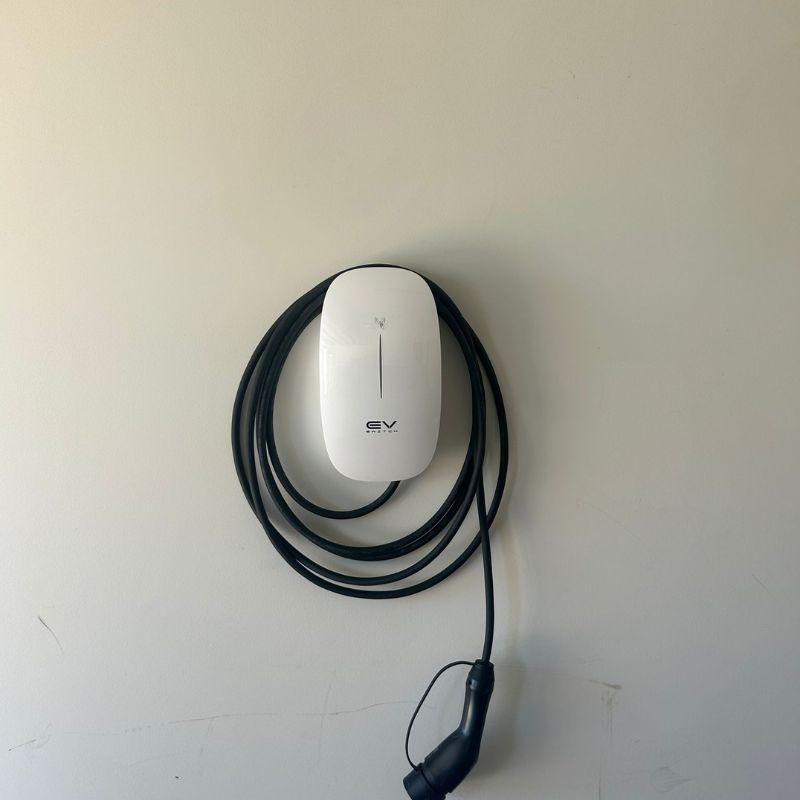 White EV switch charging station on a plain wall