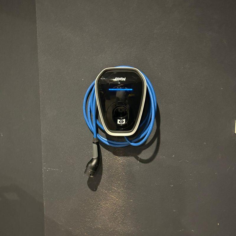 BMW electric vehicle charging on a dark surface