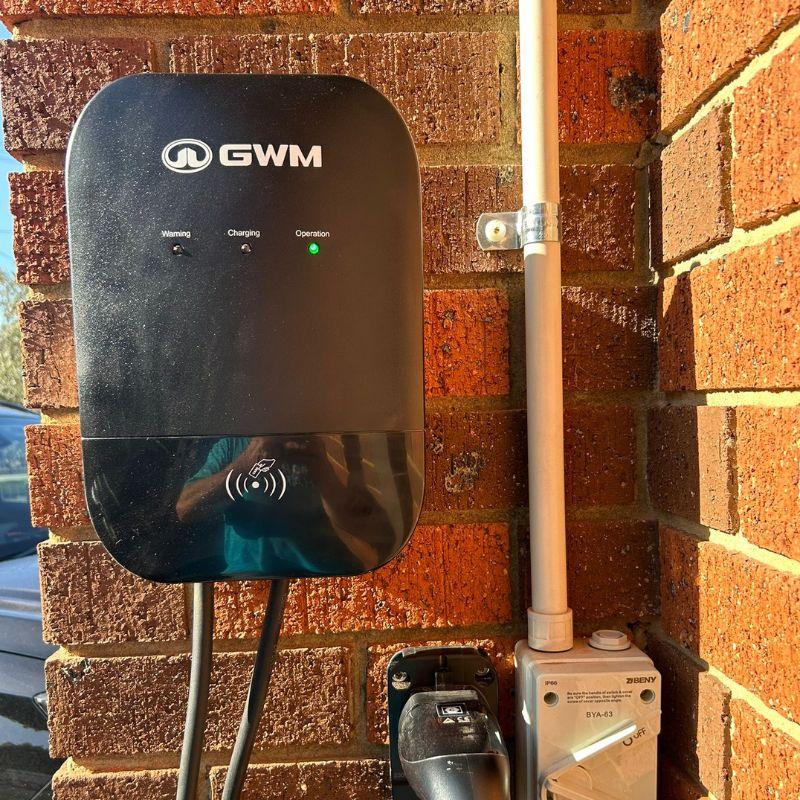 GWM electric vehicle charger mounted on a brick wall