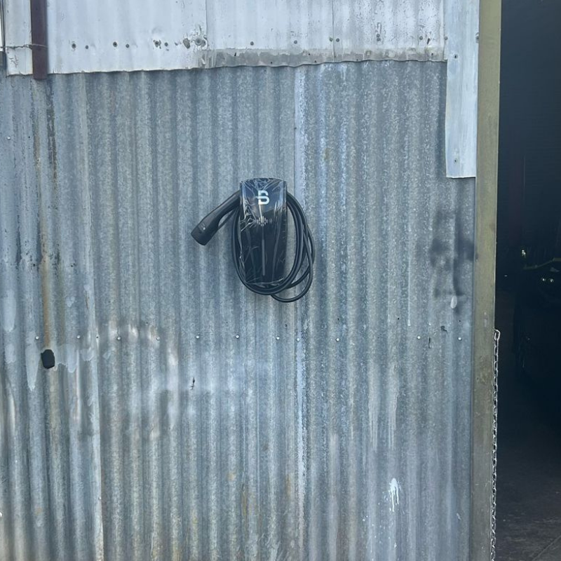 Beny EV charger on a corrugated metal wall