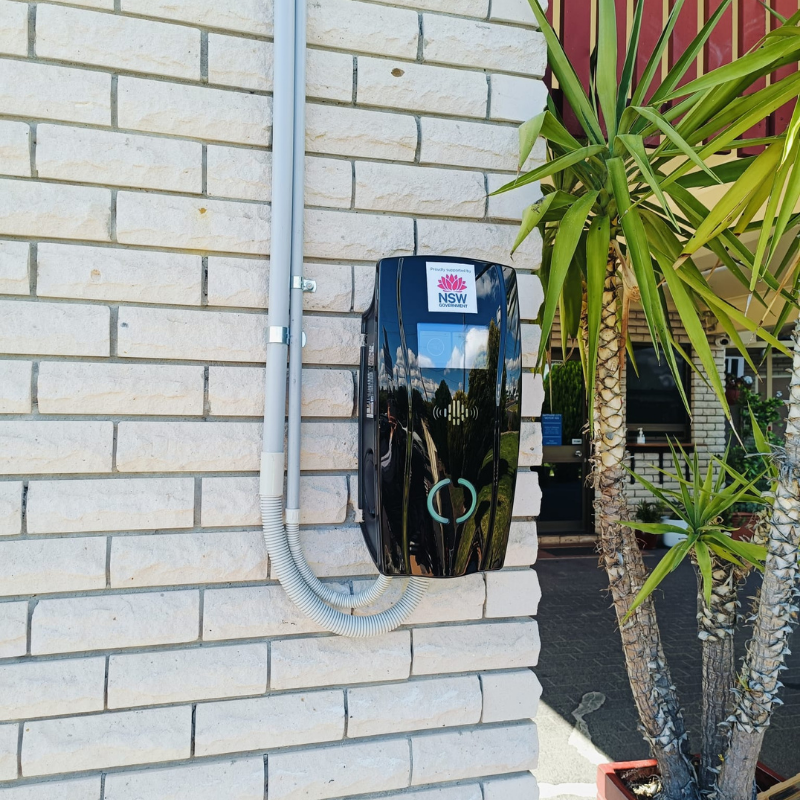 Electric vehicle charging station mounted on a brick wall 