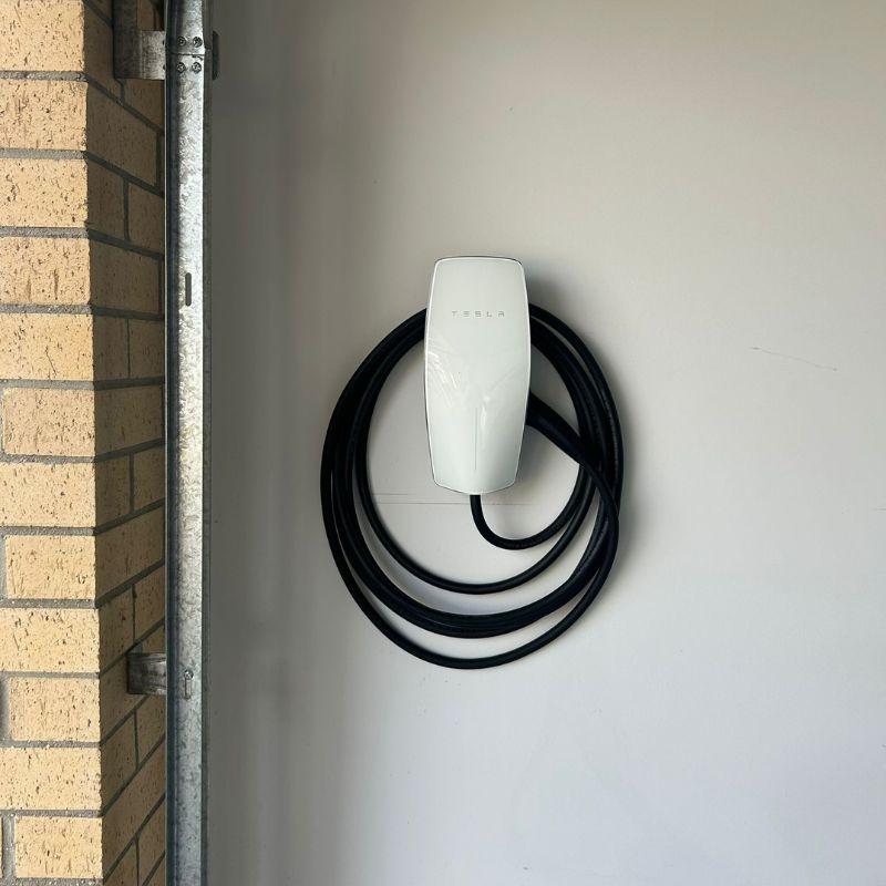 Tesla wall connector mounted on a wall