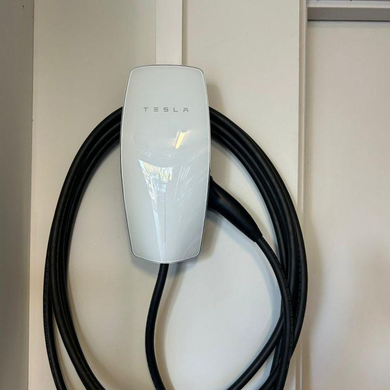 Tesla wall connector electric vehicle charging mounted on the wall 