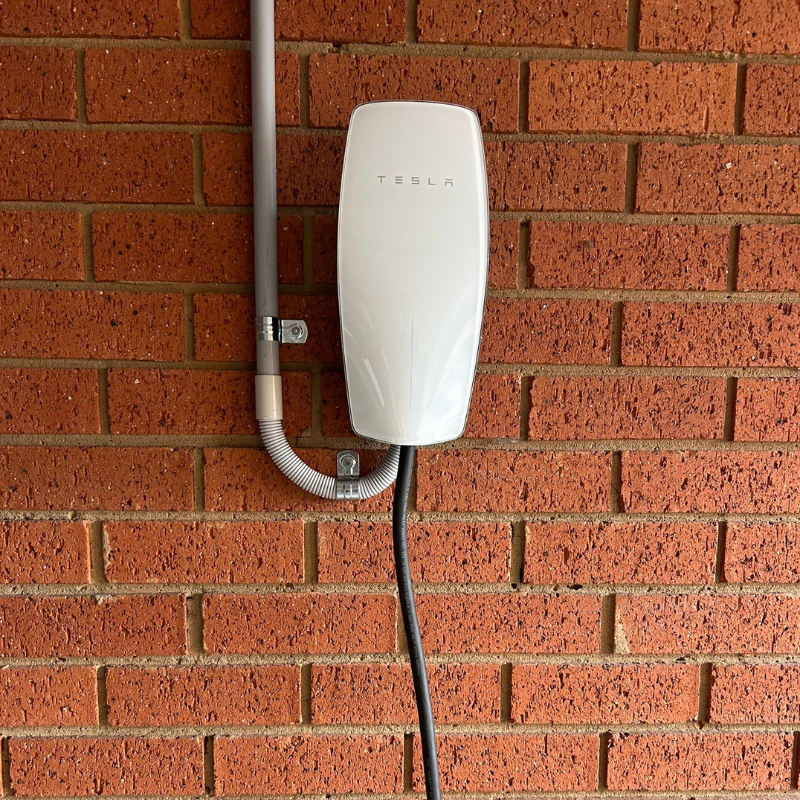 Tesla Gen 3 attached to the brick wall 