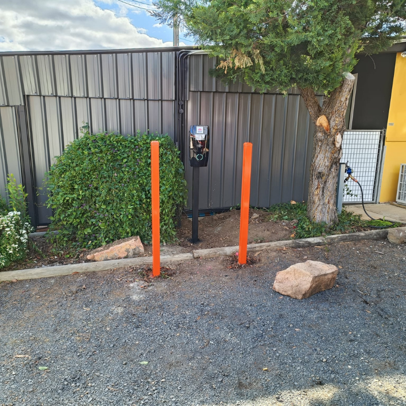 Installed on an oustide setting is a black ev charger