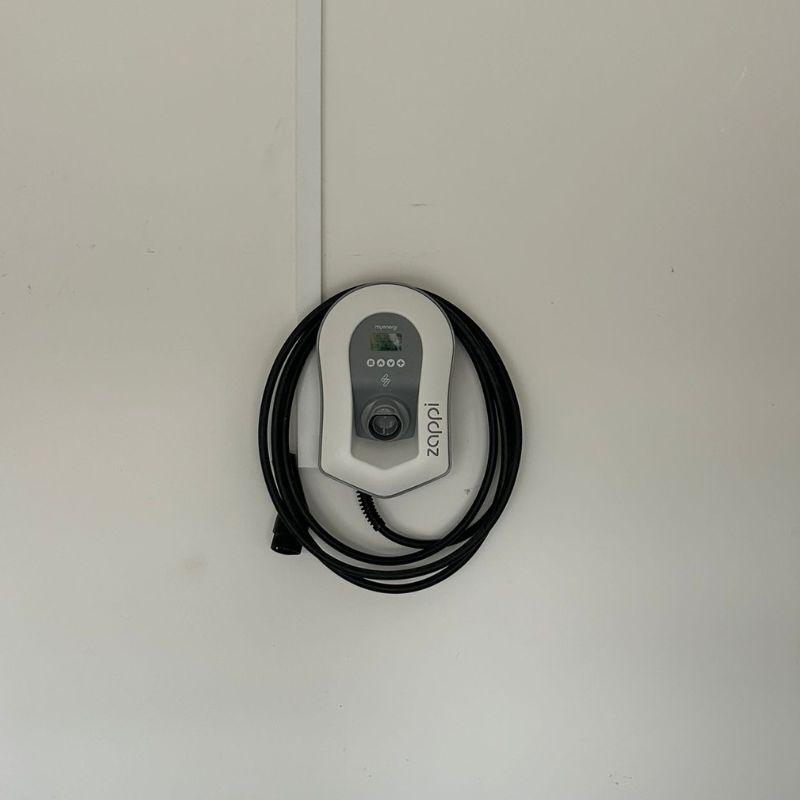 Wall-mounted white Zappi electric vehicle charging station 